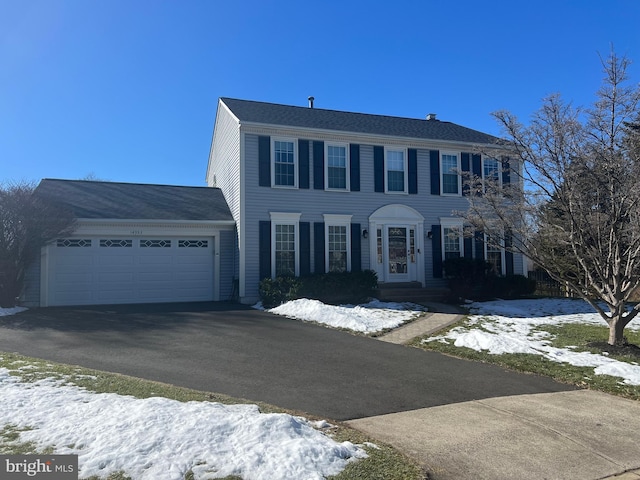 colonial home with driveway and an attached garage