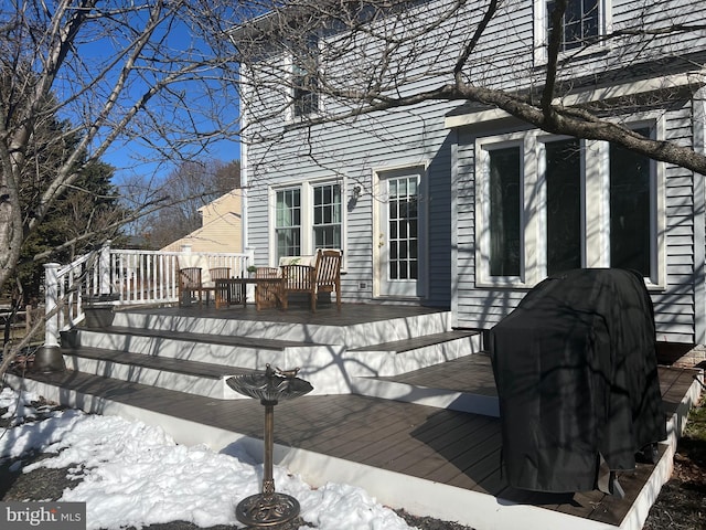 snow covered deck featuring area for grilling