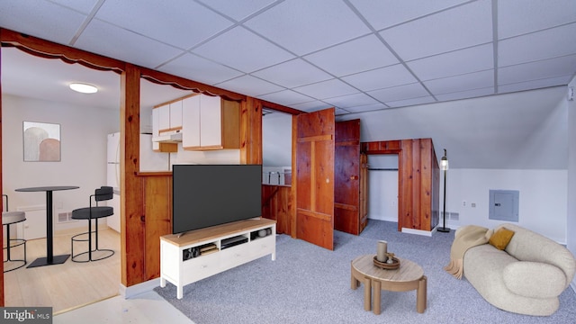 living room featuring a paneled ceiling and electric panel