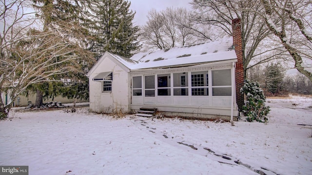 view of snow covered rear of property