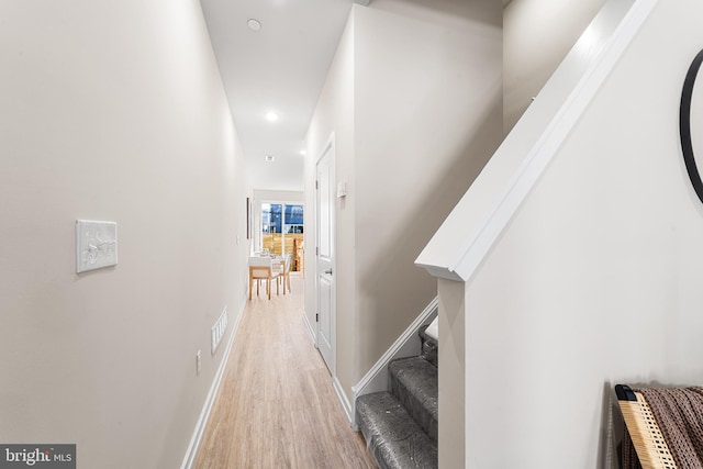 hall featuring recessed lighting, visible vents, stairway, light wood-style floors, and baseboards