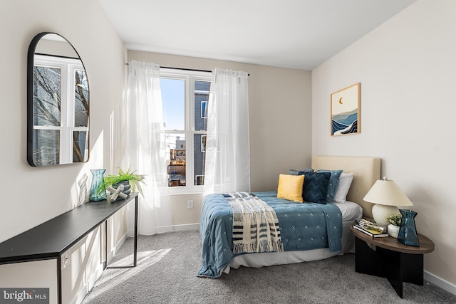 bedroom with carpet floors and baseboards