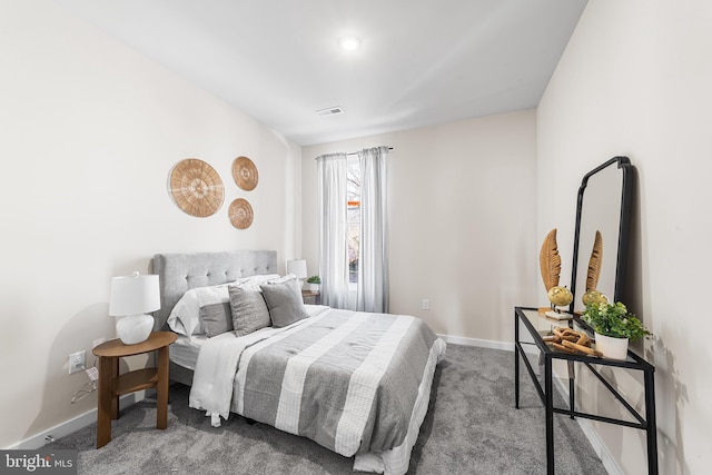 carpeted bedroom featuring visible vents and baseboards