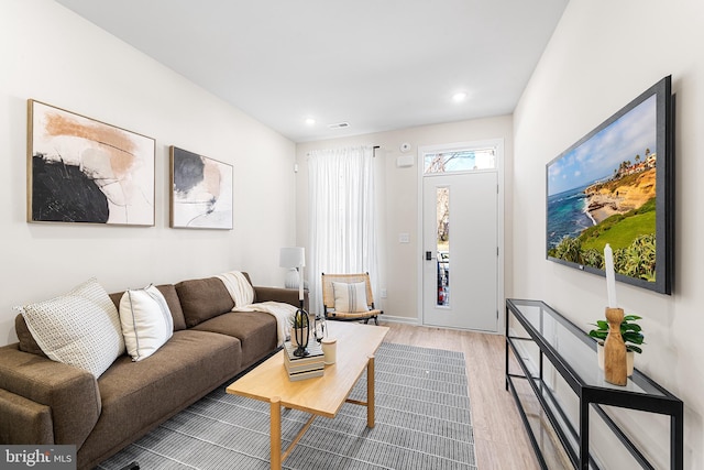 living room featuring light wood-style floors, recessed lighting, and visible vents