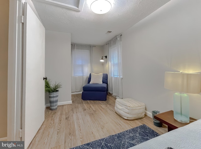 sitting room featuring wood-type flooring and a textured ceiling