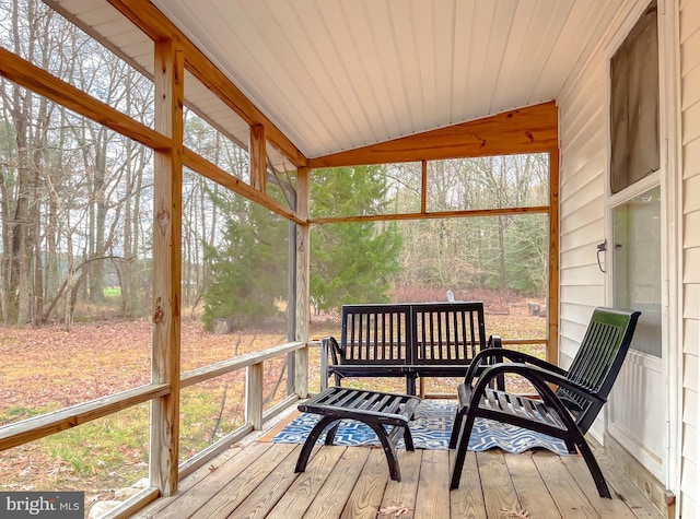 sunroom featuring vaulted ceiling and wooden ceiling