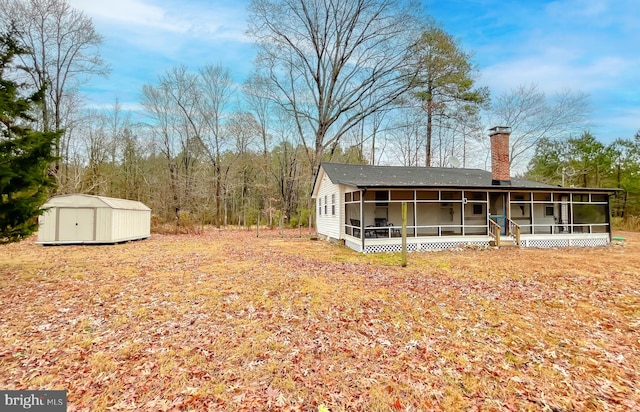 view of yard featuring a shed and a sunroom