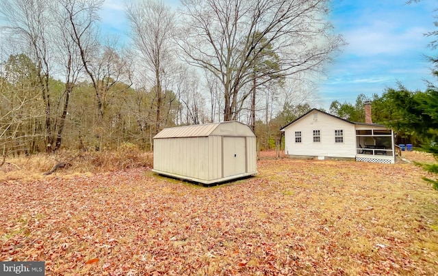 view of outdoor structure with a sunroom