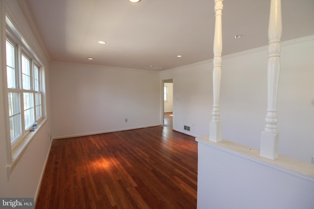 spare room with visible vents, dark wood finished floors, crown molding, and recessed lighting