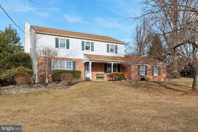 view of front of home with covered porch and a front yard