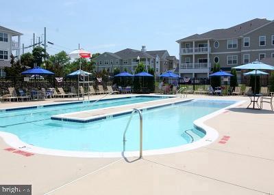 pool with a residential view, fence, and a patio