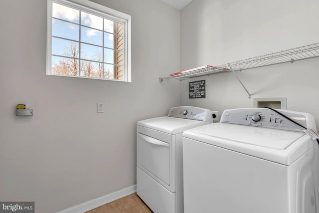 laundry area with laundry area, washer and clothes dryer, and baseboards