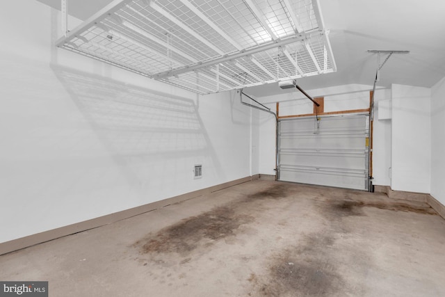 garage with baseboards and a garage door opener