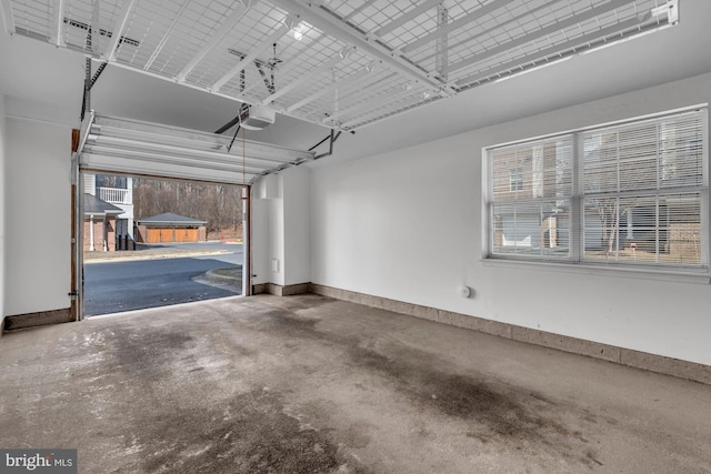 garage with baseboards and a garage door opener