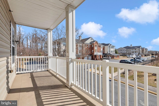 balcony featuring covered porch and a residential view