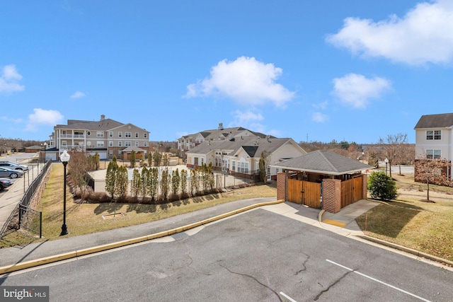 view of road with a residential view, curbs, and street lights