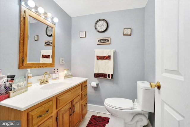 bathroom featuring tile patterned floors, toilet, and vanity