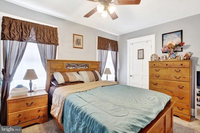 bedroom with light carpet and ceiling fan