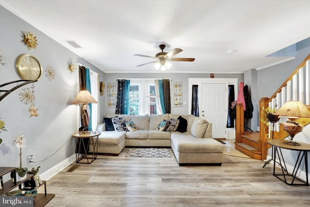 living room featuring crown molding, ceiling fan, and light hardwood / wood-style flooring