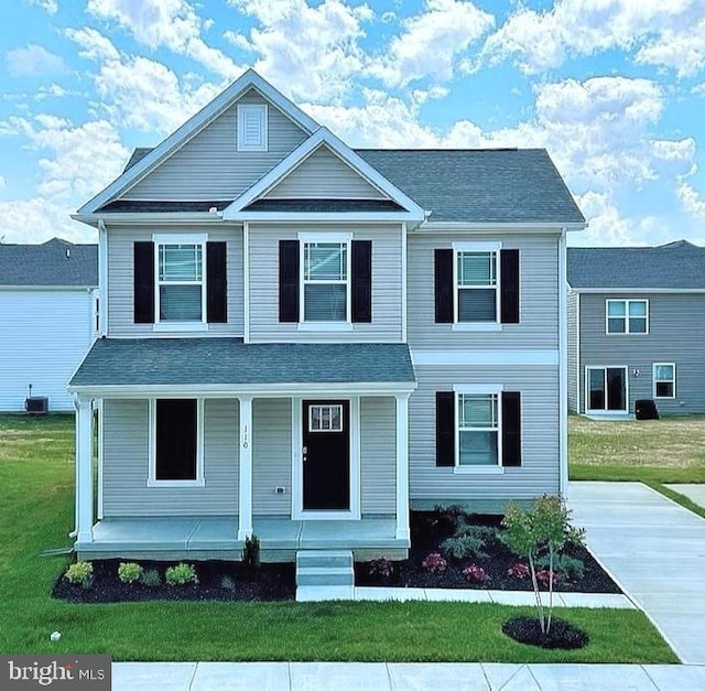 view of front facade with a front lawn and a porch