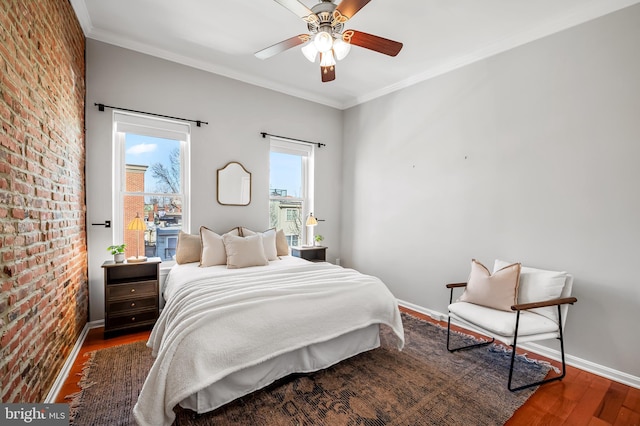 bedroom featuring crown molding, dark hardwood / wood-style flooring, brick wall, and ceiling fan