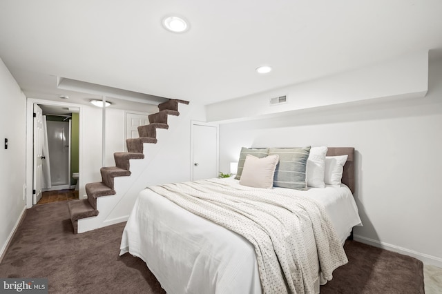 bedroom featuring dark colored carpet