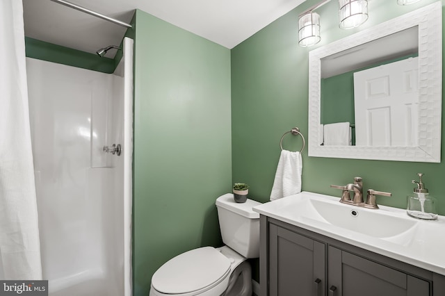 bathroom with toilet, vanity, and curtained shower