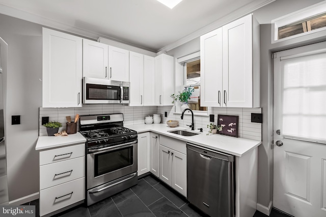 kitchen featuring white cabinets, appliances with stainless steel finishes, sink, and a wealth of natural light