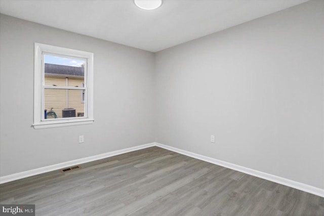 unfurnished room with wood-type flooring