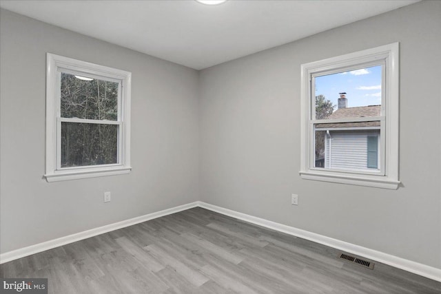 unfurnished room with hardwood / wood-style floors