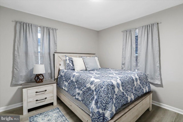 bedroom with dark hardwood / wood-style floors