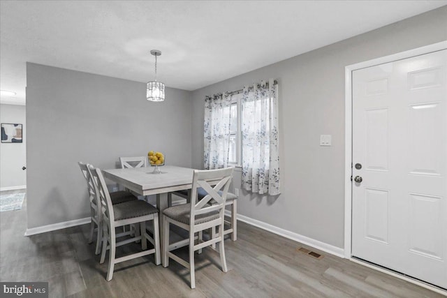 dining area with wood-type flooring