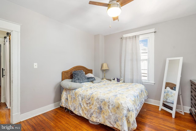 bedroom featuring hardwood / wood-style flooring and ceiling fan