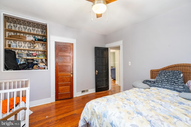 bedroom with ceiling fan and hardwood / wood-style floors