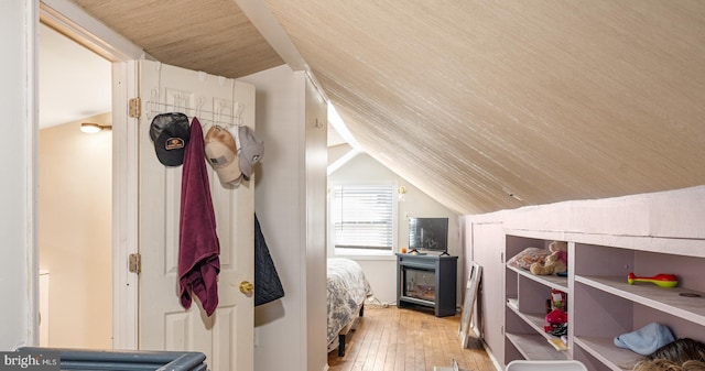 bedroom featuring lofted ceiling and light wood-type flooring