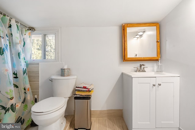 bathroom with vanity, hardwood / wood-style floors, curtained shower, and toilet