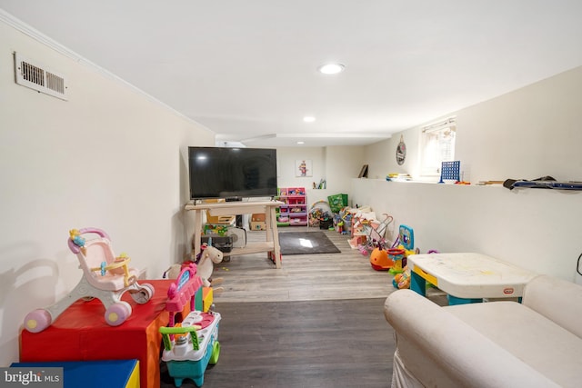 playroom with hardwood / wood-style floors and ornamental molding