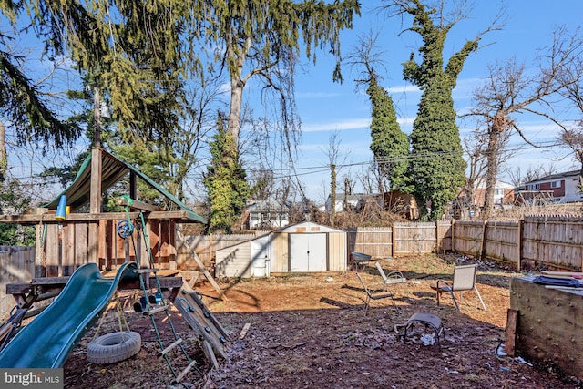 view of yard with a playground and a shed