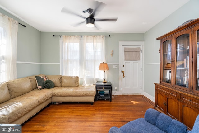 living room with hardwood / wood-style floors and ceiling fan