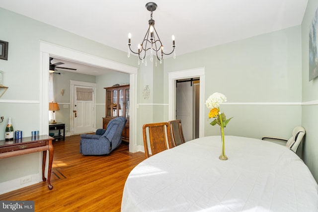 dining area with hardwood / wood-style flooring and ceiling fan