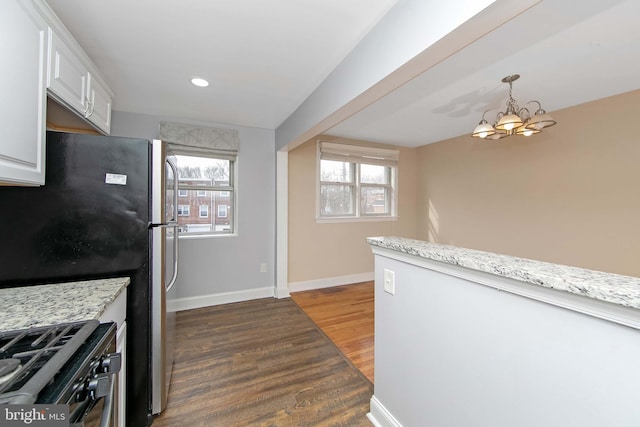 kitchen featuring gas range oven, white cabinetry, plenty of natural light, and dark hardwood / wood-style floors