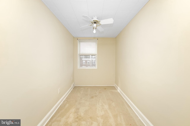 empty room with ceiling fan and light colored carpet