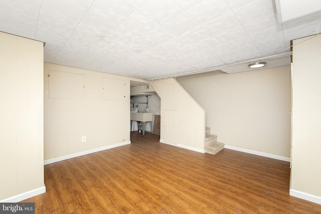 basement with hardwood / wood-style flooring