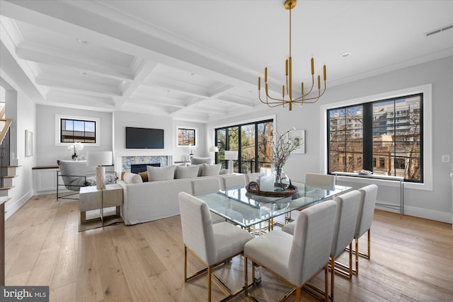 dining space with coffered ceiling, beam ceiling, light hardwood / wood-style flooring, and a chandelier