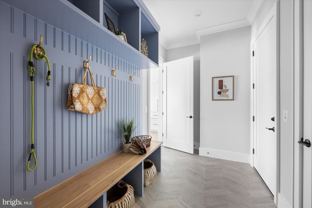 mudroom featuring crown molding and parquet floors