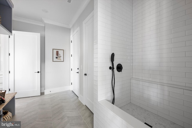 bathroom featuring ornamental molding and a tile shower