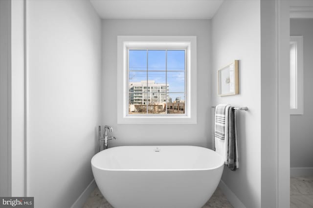 bathroom with a tub to relax in