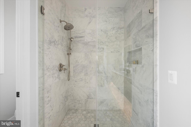 bathroom featuring a shower with door