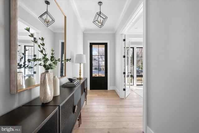 foyer featuring crown molding and light hardwood / wood-style flooring