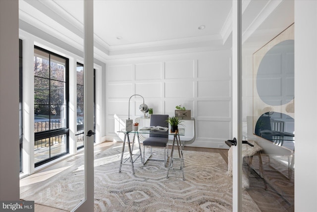 office area with french doors, ornamental molding, and light hardwood / wood-style flooring